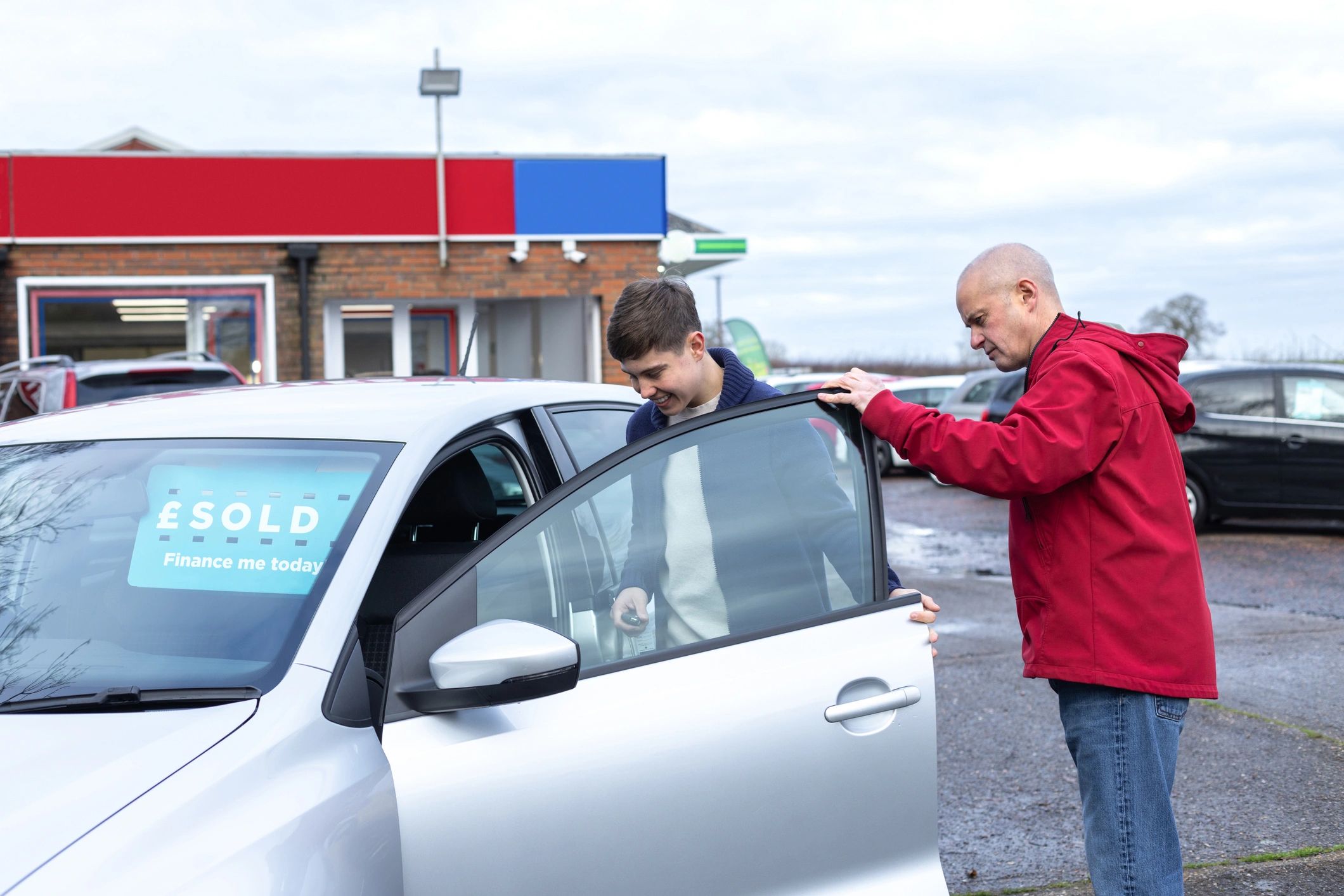 Customer inspecting a vehicle at a dealership