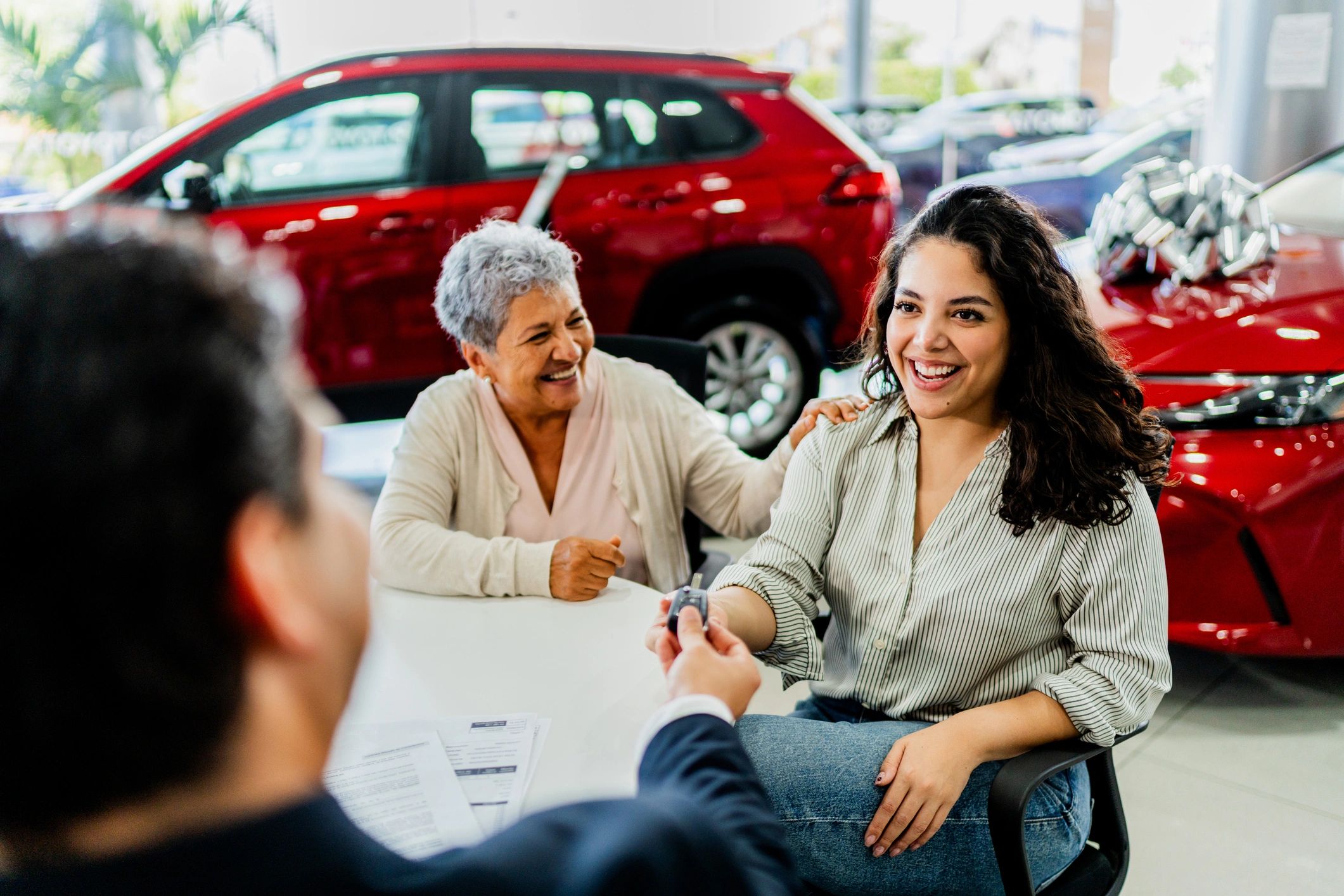 Customer receiving keys at a car dealership