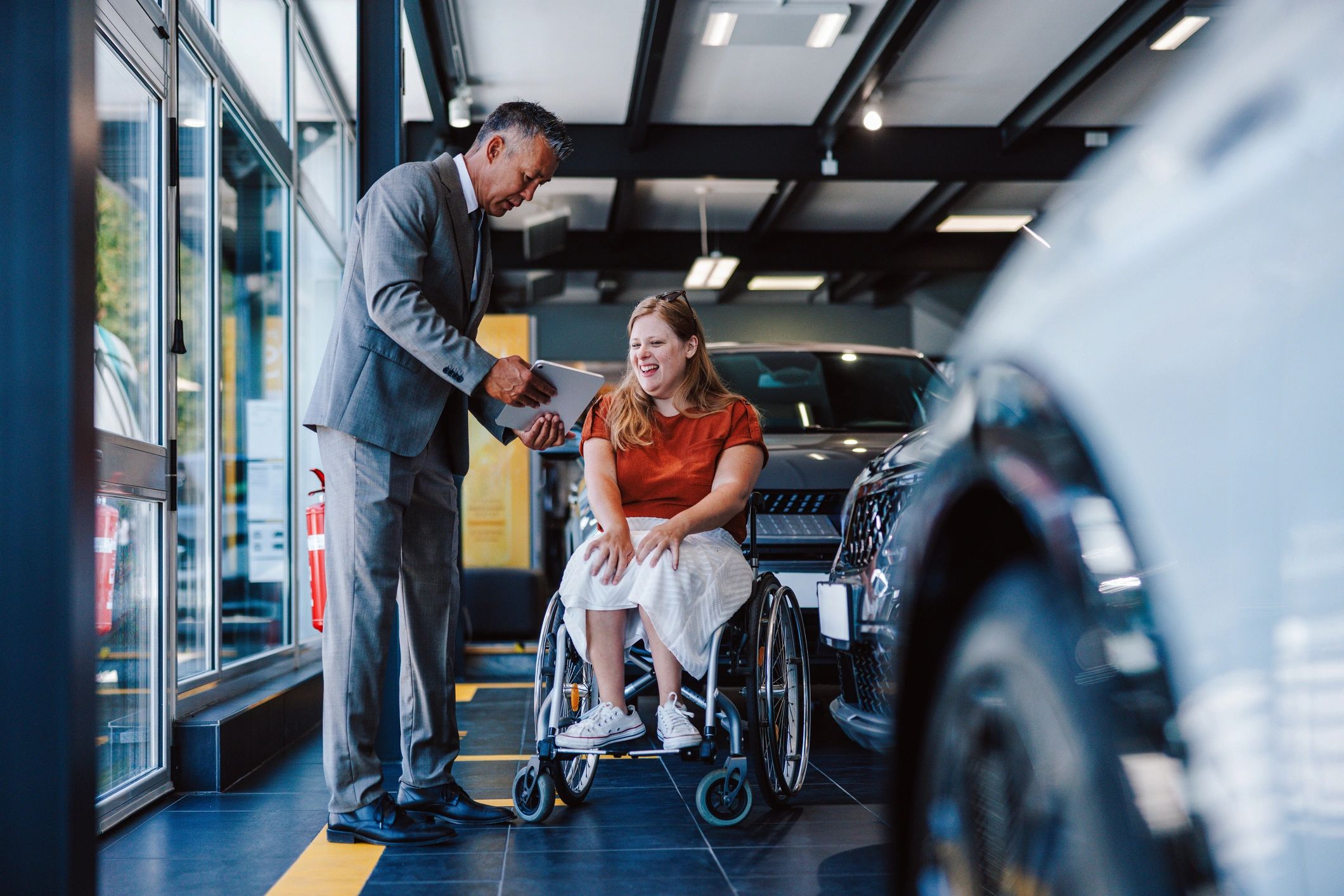 Customer receiving assistance in a car showroom